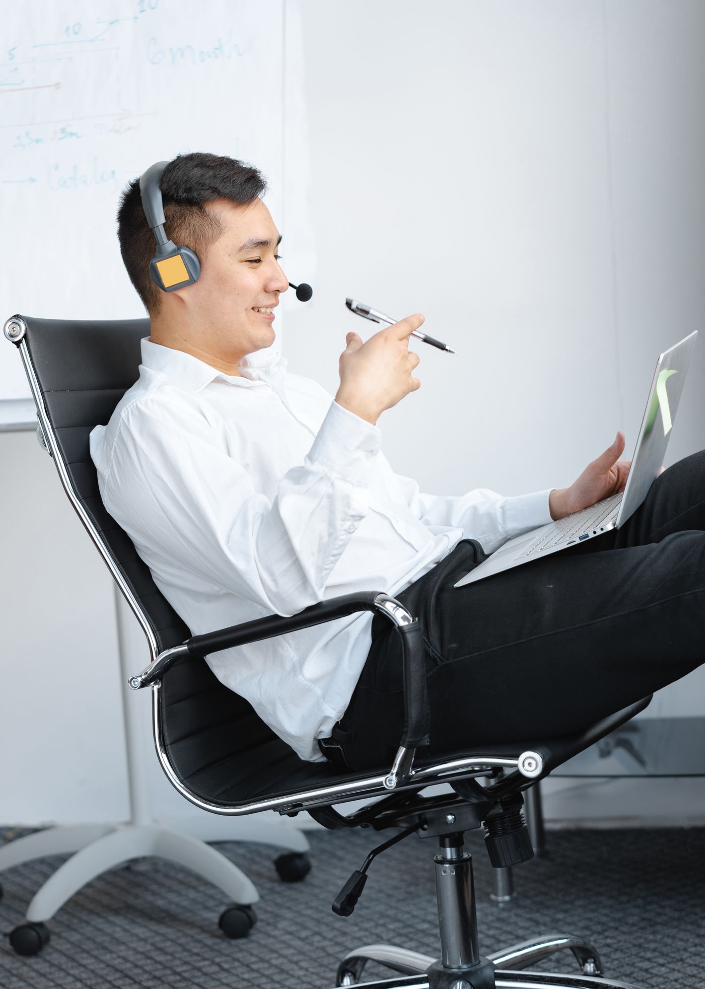 Man on a headset with a laptop